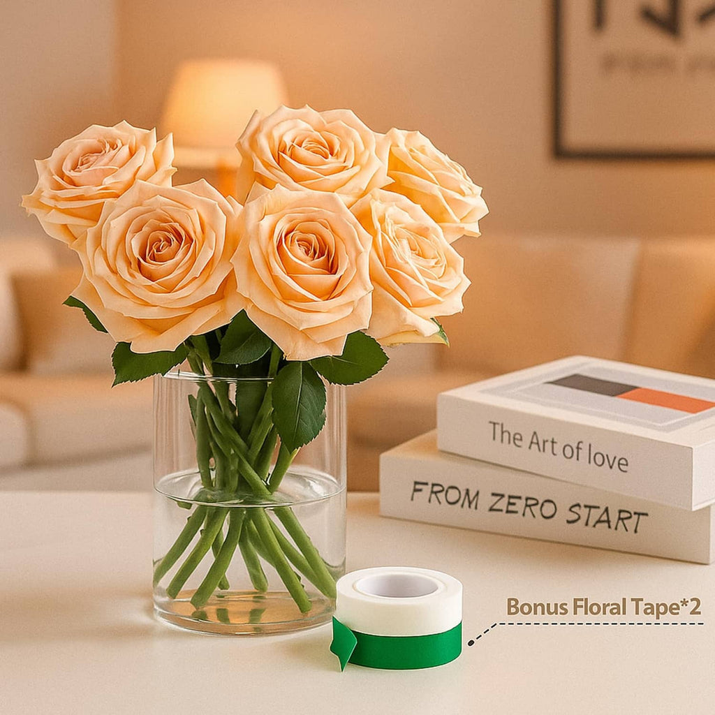 Clear glass cylinder vase holding peach roses and green stems