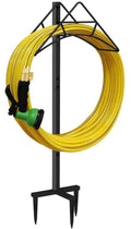 Free-standing garden hose reel stand with yellow hose looped on black metal frame