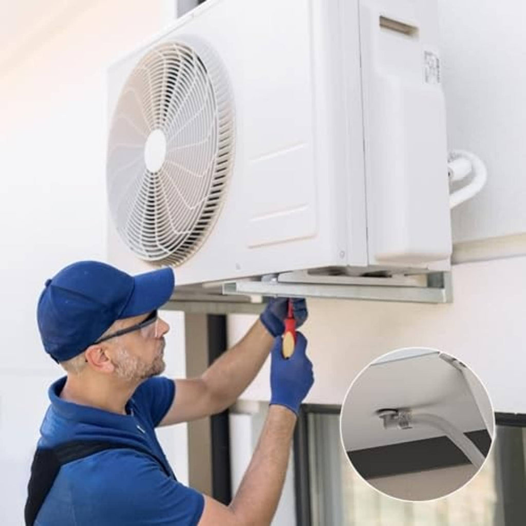 Technician connecting a clear AC drain hose to a portable air conditioner outlet