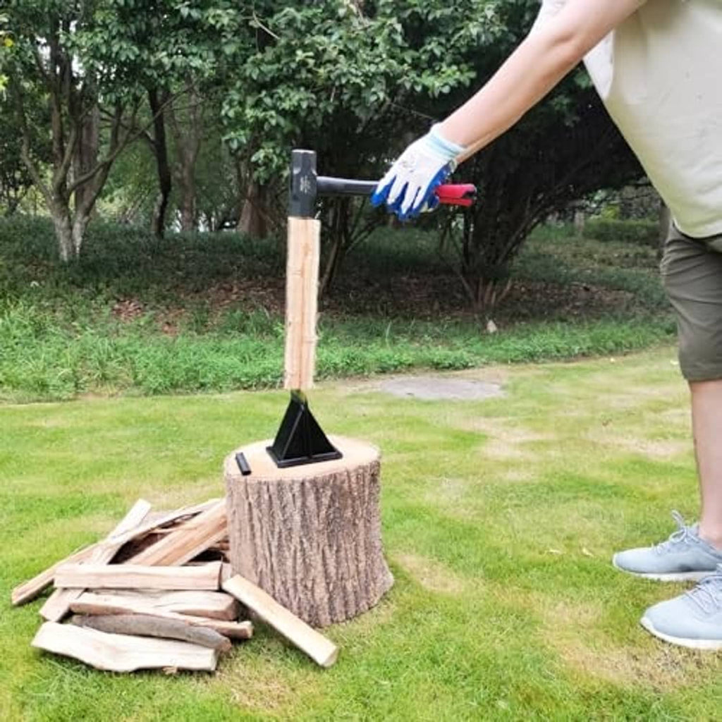 Log splitting wedge standing on a stump during wood splitting outdoors