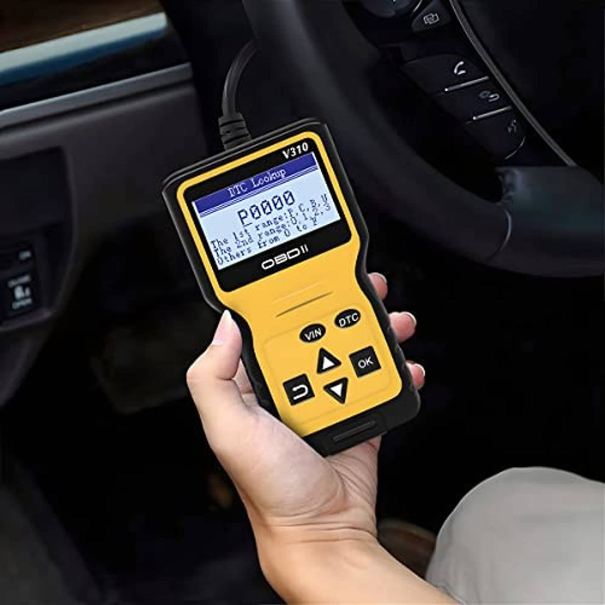AUCELI OBD2 code scanner displaying diagnostic code on screen in hand