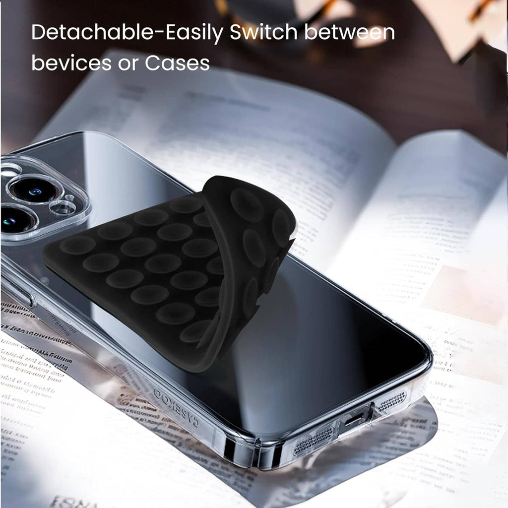 Black silicone suction-cup grip attached to phone case on the side