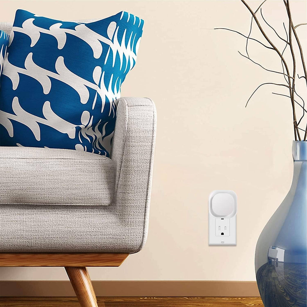 Plug-in night light glowing blue on a wall near a sofa