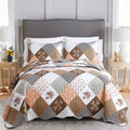 Reversible twin quilt set with brown floral plaid patchwork and white backing