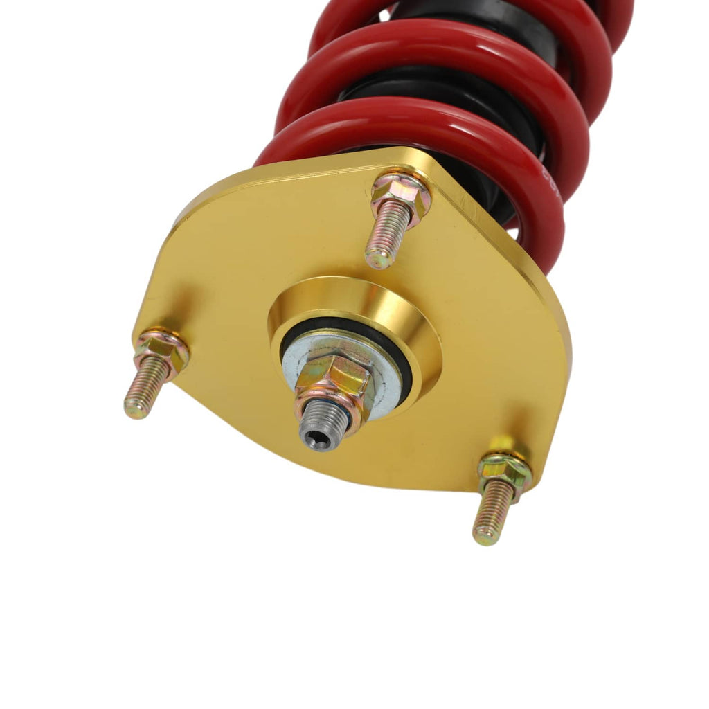 Coilover strut top hat mount with red spring and gold circular plate
