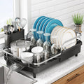Expandable black dish drying rack with utensil holder and dish drain rails