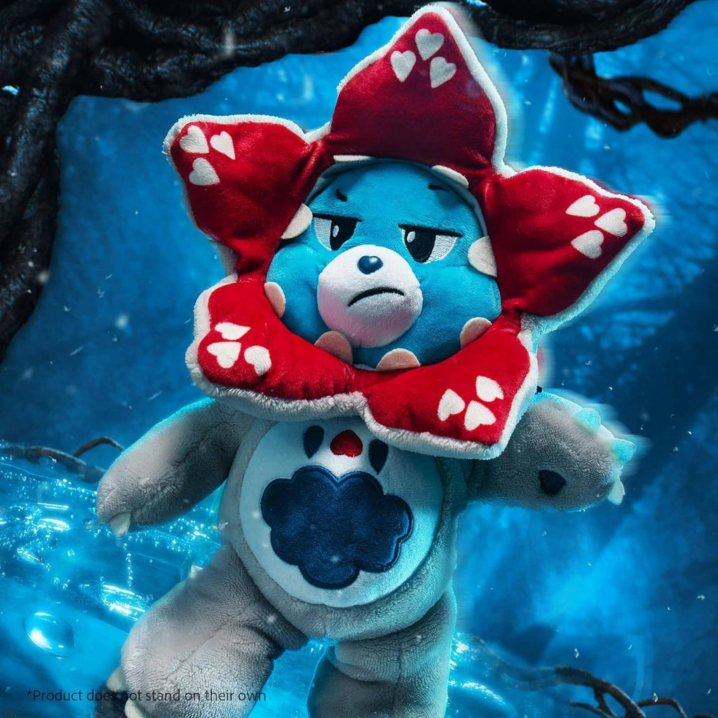 Plush blue bear with red heart hood and gray outfit, standing