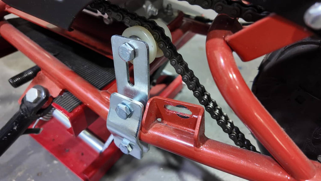 Chain tensioner bracket mounted on engine frame, with guide wheel and bolts