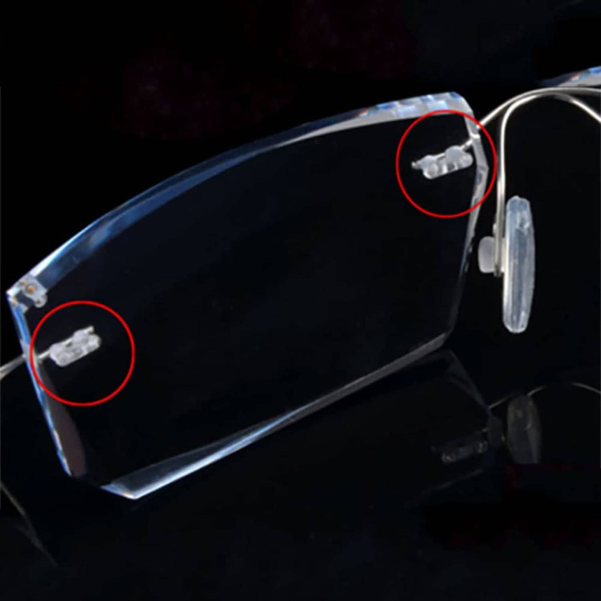 Clear double rubber plugs on rimless eyeglass arm, close-up of plug attachment