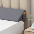 Gray bed wedge pillow with side storage pocket, angled for elevated head and support.