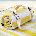Lemon yellow and white striped beach blanket with carry straps and buckle