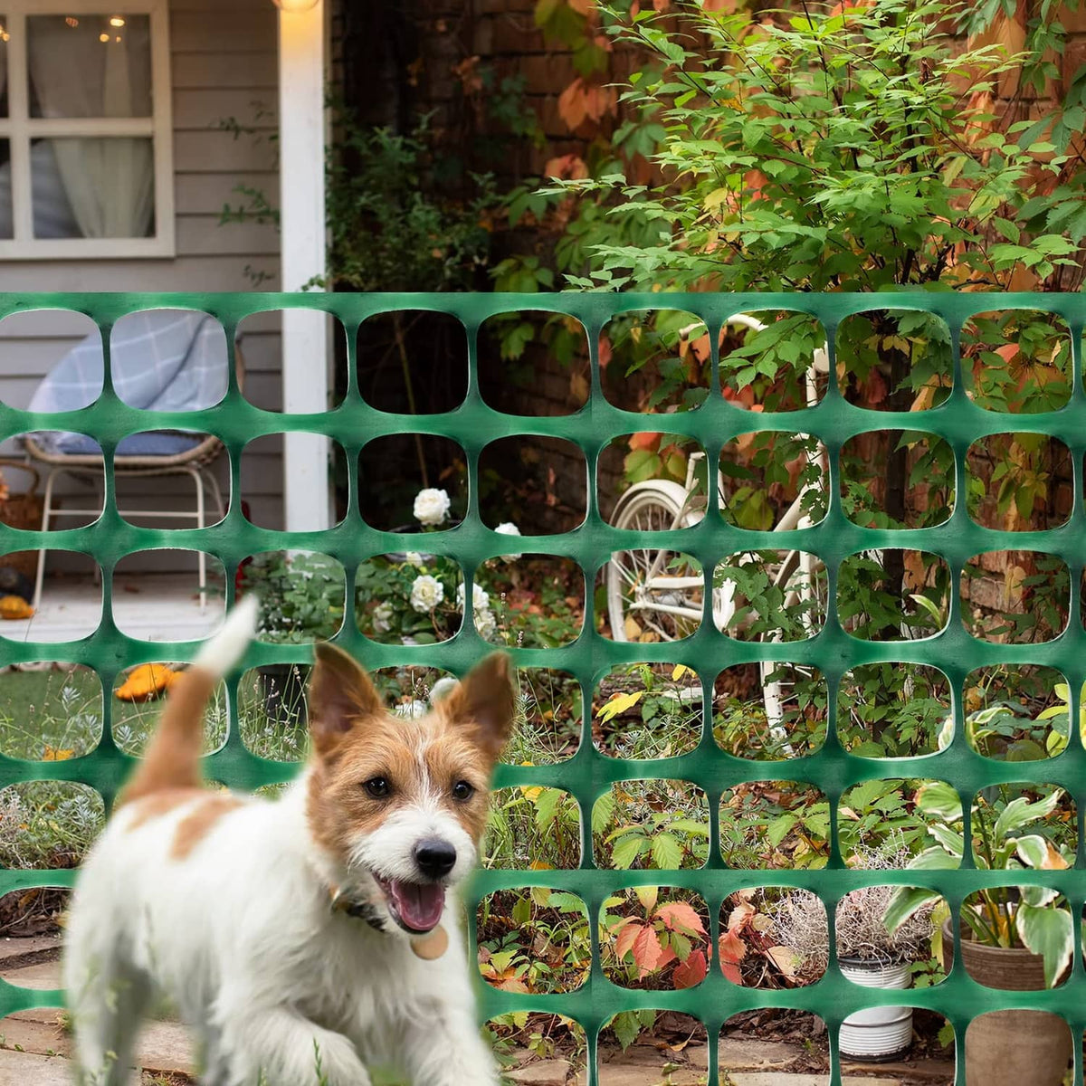 Green plastic mesh safety fence barrier with pet behind square openings