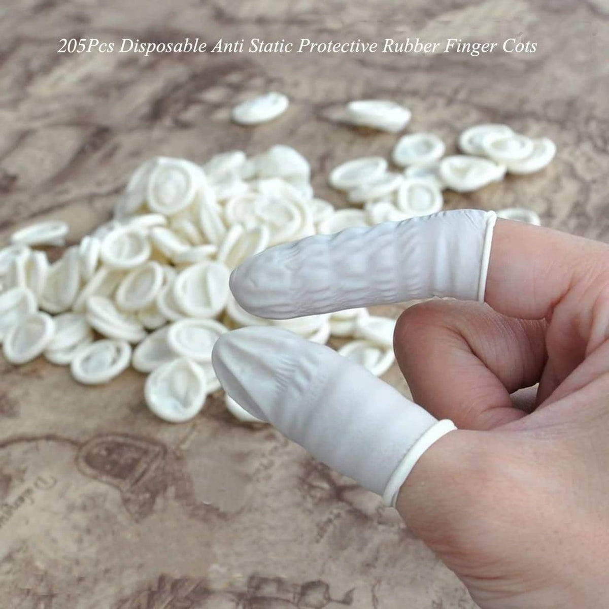 Hand wearing white latex finger cot over fingertips for disposable protection