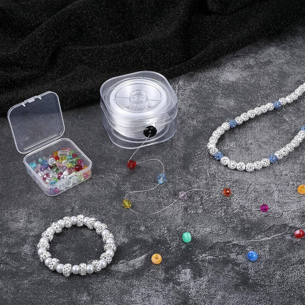 White elastic string spool with beads and stretch bracelets laid out for making
