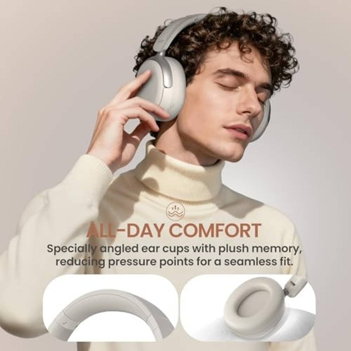 White over-ear headphones worn by a person with curly hair, close-up on ear cups.