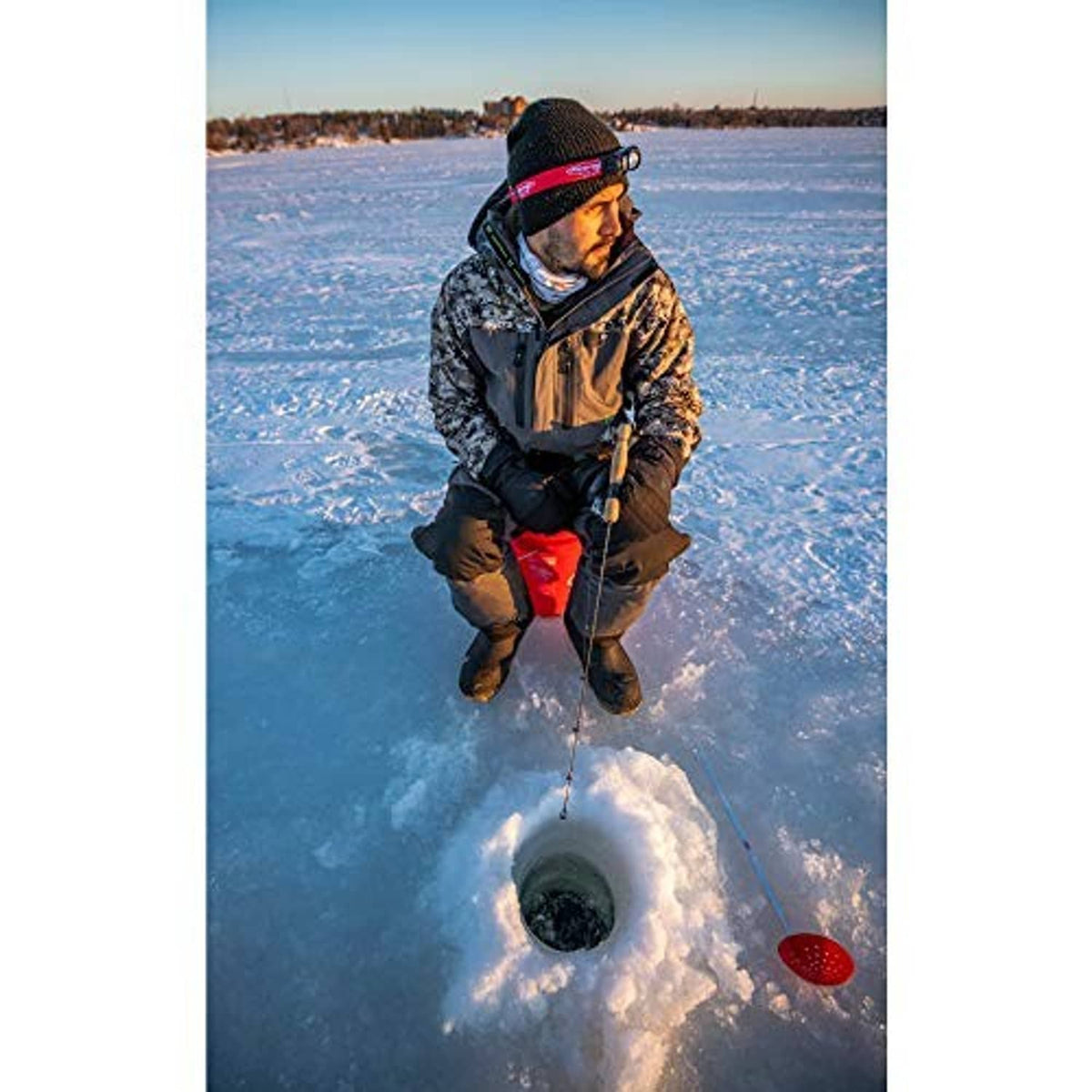 Ice fishing line pulled from an ice hole with rod and caught fish