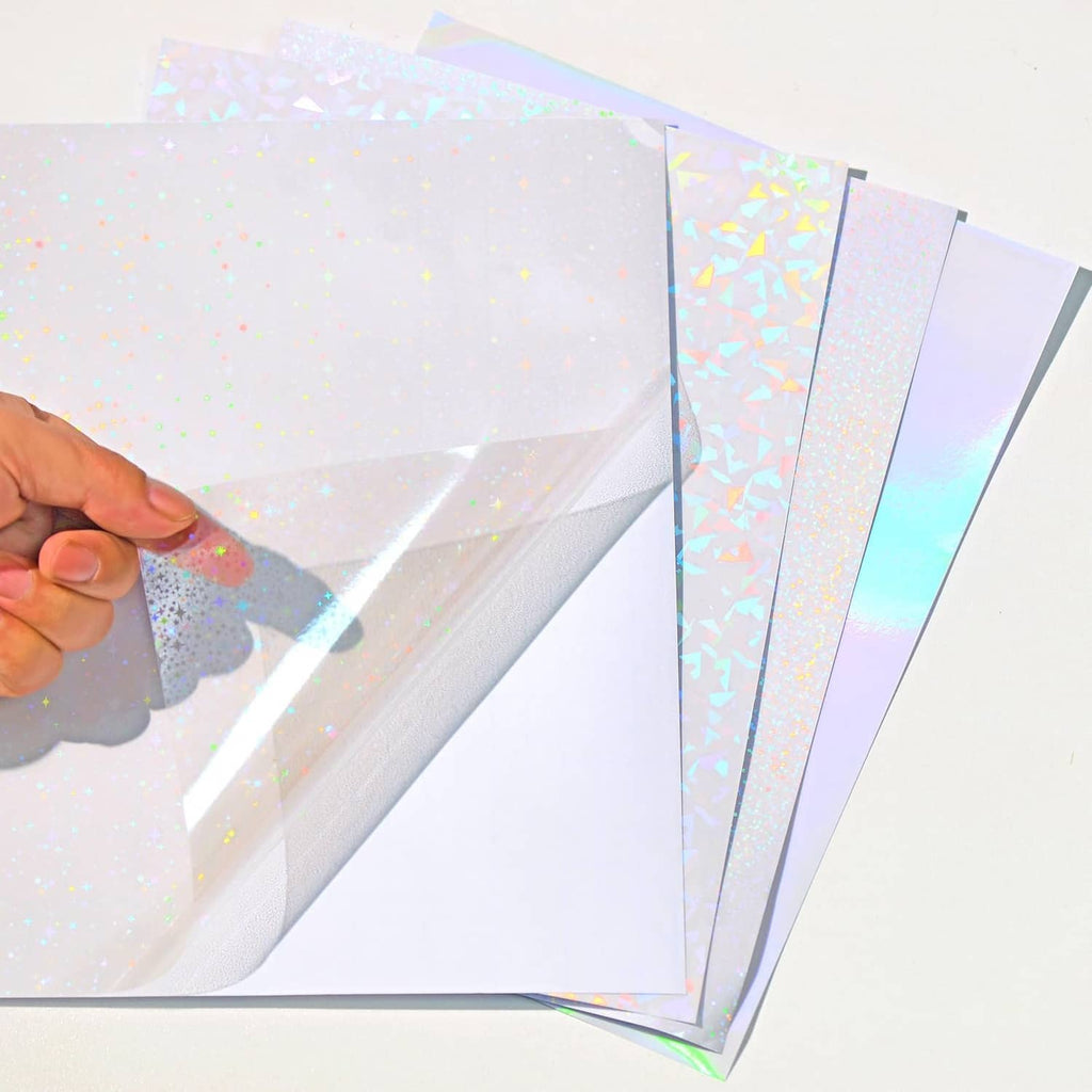 Transparent holographic laminate sheet being peeled, revealing reflective iridescent surface