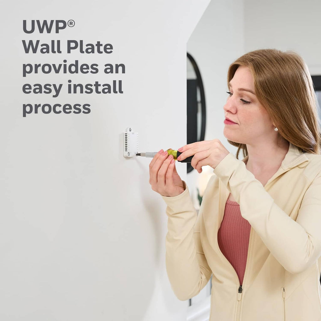 Smart thermostat wall plate installation with person mounting a device near wiring