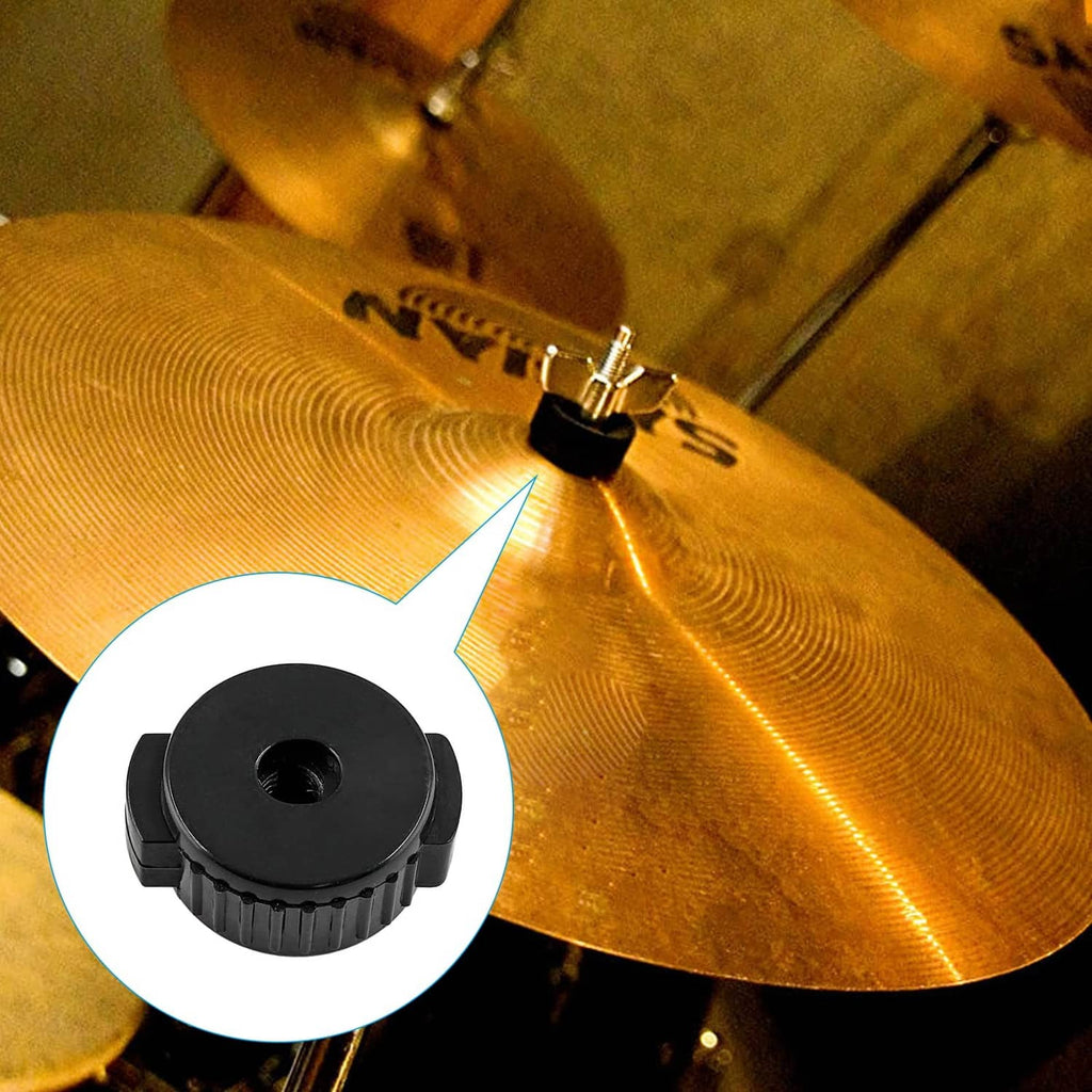 Black plastic cymbal nut near a cymbal, with ridged sides and center hole.