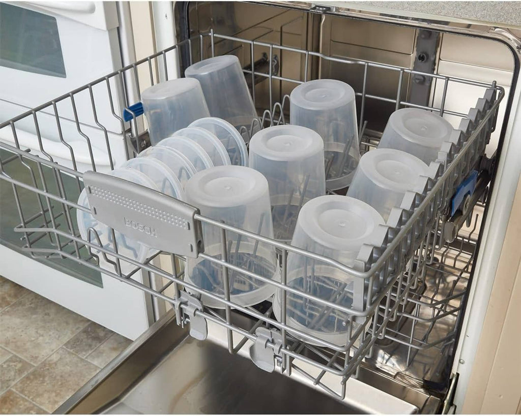 Clear deli food containers with white lids loaded in a dishwasher rack