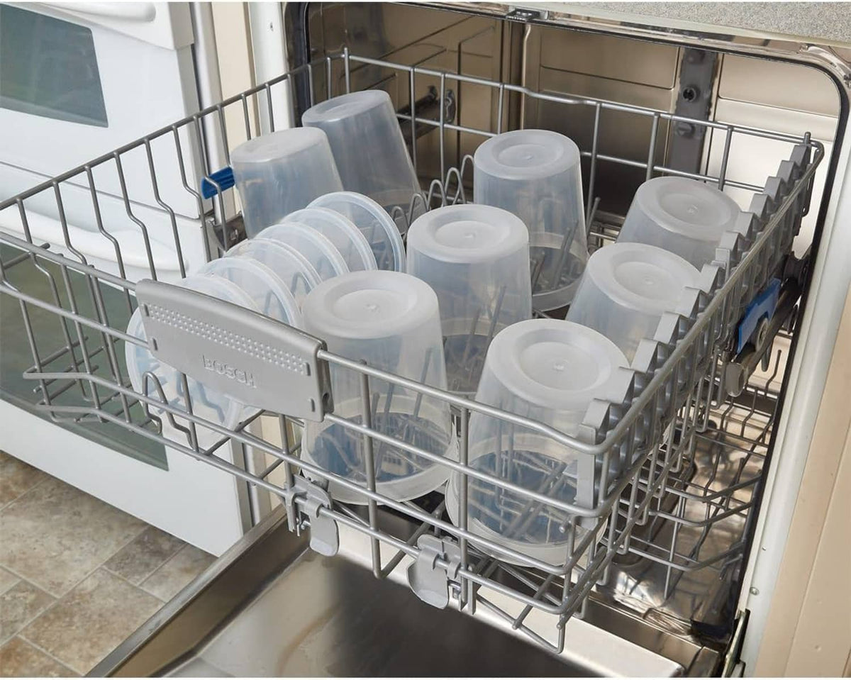 Clear deli food containers with white lids loaded in a dishwasher rack