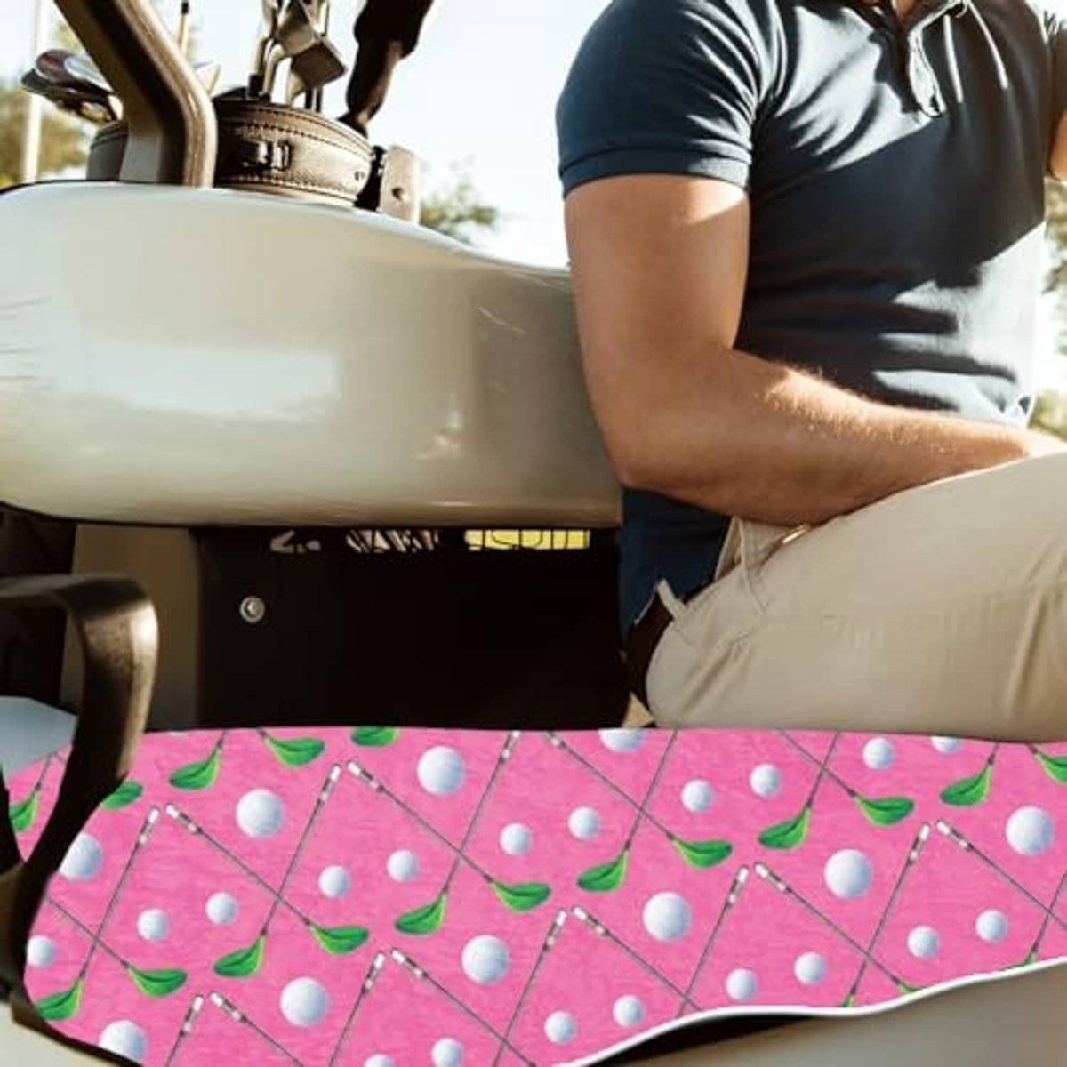 Golf cart seat cover with pink leaf-and-dot pattern on front seat while seated