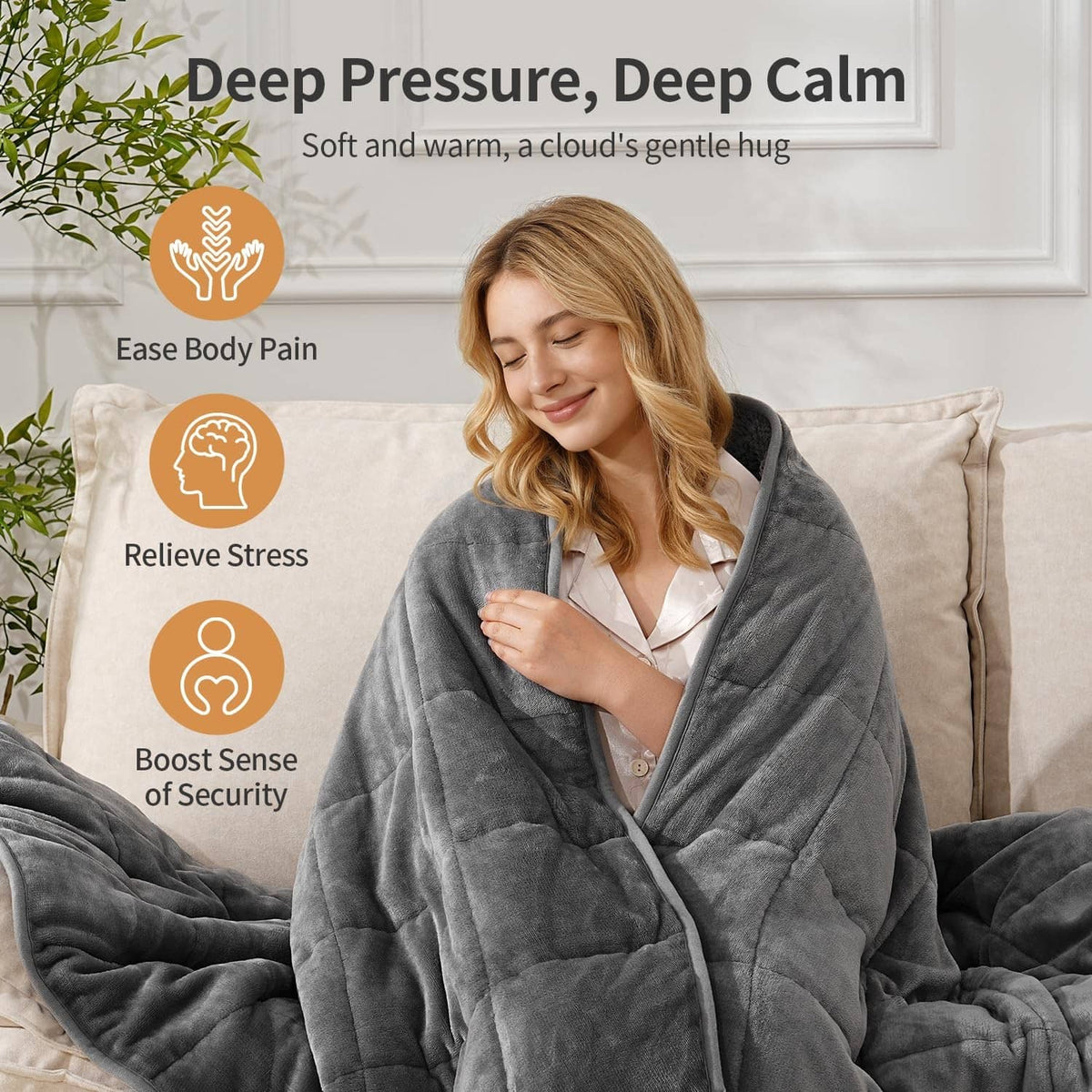 Grey weighted blanket wrapped around a woman in a cozy lounge pose