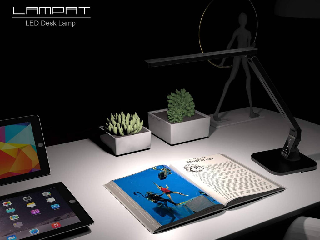 Black LED desk lamp illuminating an open book on a work desk