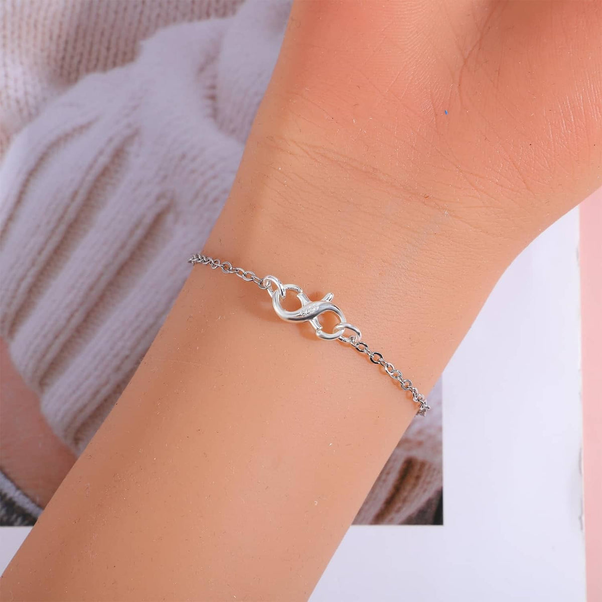 Sterling silver lobster claw clasp on necklace chain with oval links near wrist