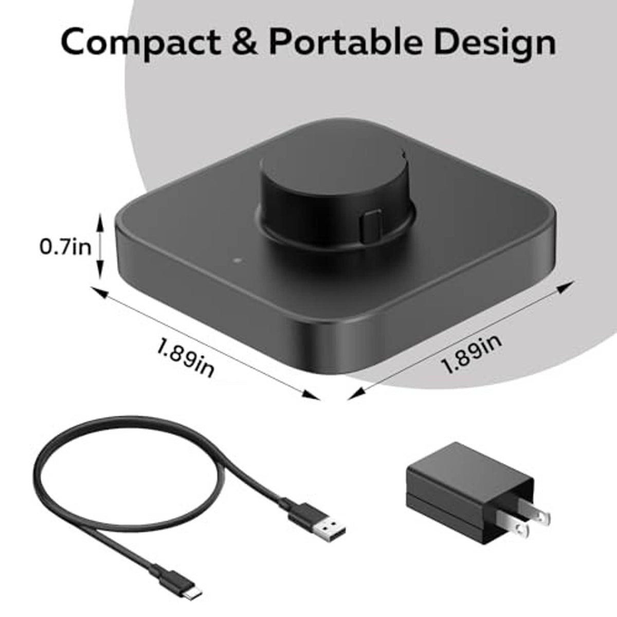 Compact black charging dock with circular cradle, USB cable, and plug adapter