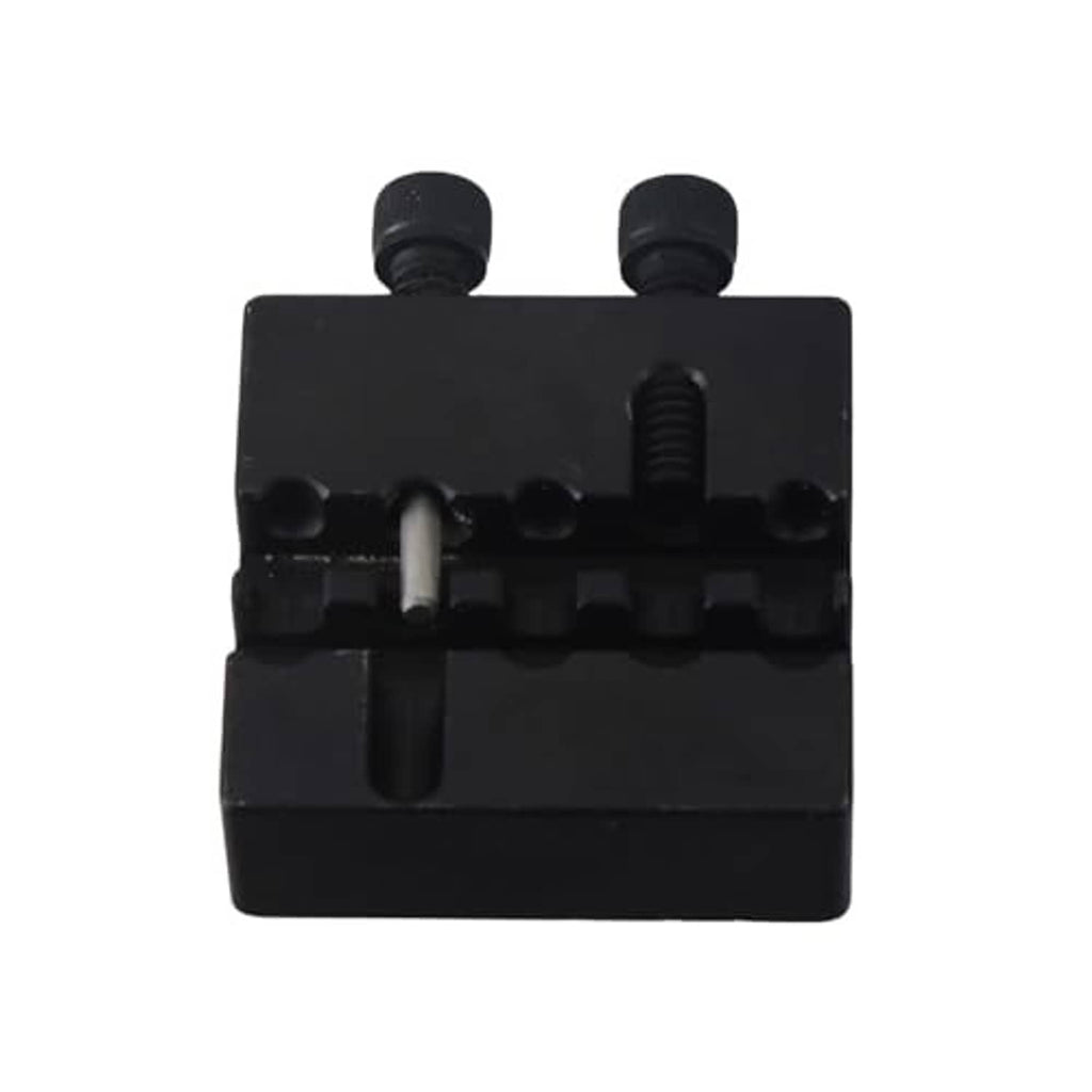 Black chain breaker tool underside with central punch and two screws
