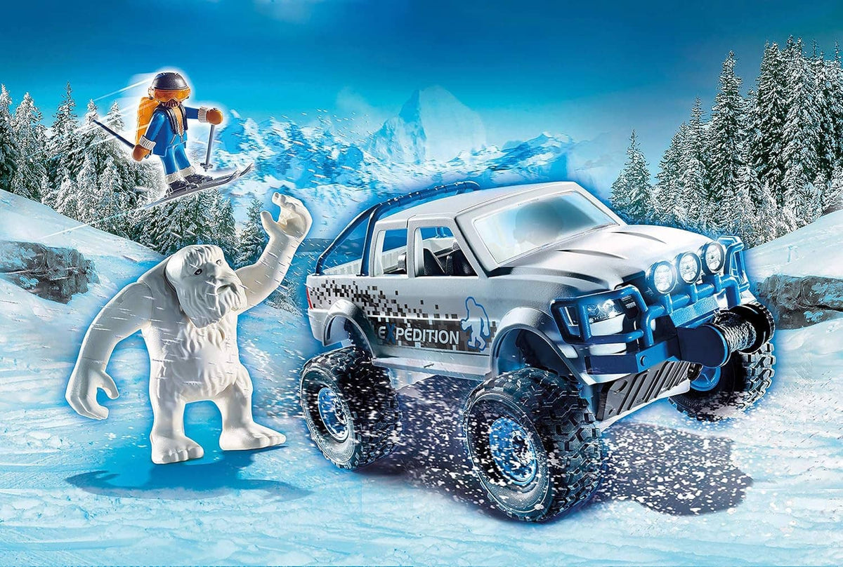 Playmobil off-road snow truck with driver and white dog standing beside it