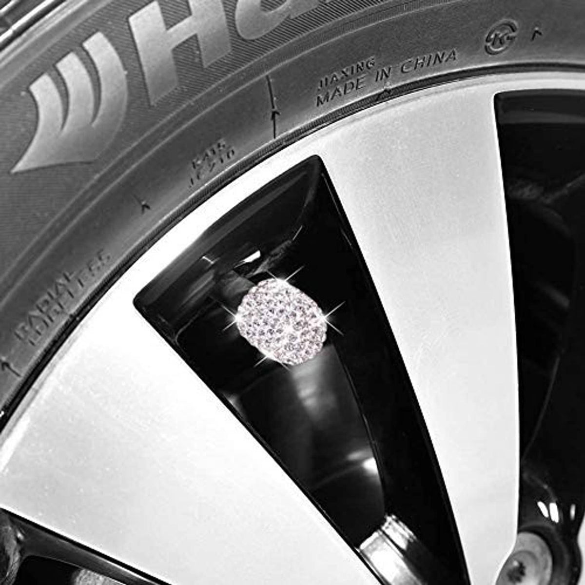 Crystal rhinestone valve stem cap close-up on silver wheel rim