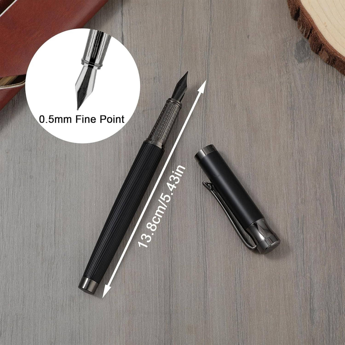Black fountain pen with fine nib and open converter cap; size marked 73 in 5 4 in