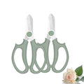Green flower scissors with two curved loop handles and stainless steel blades