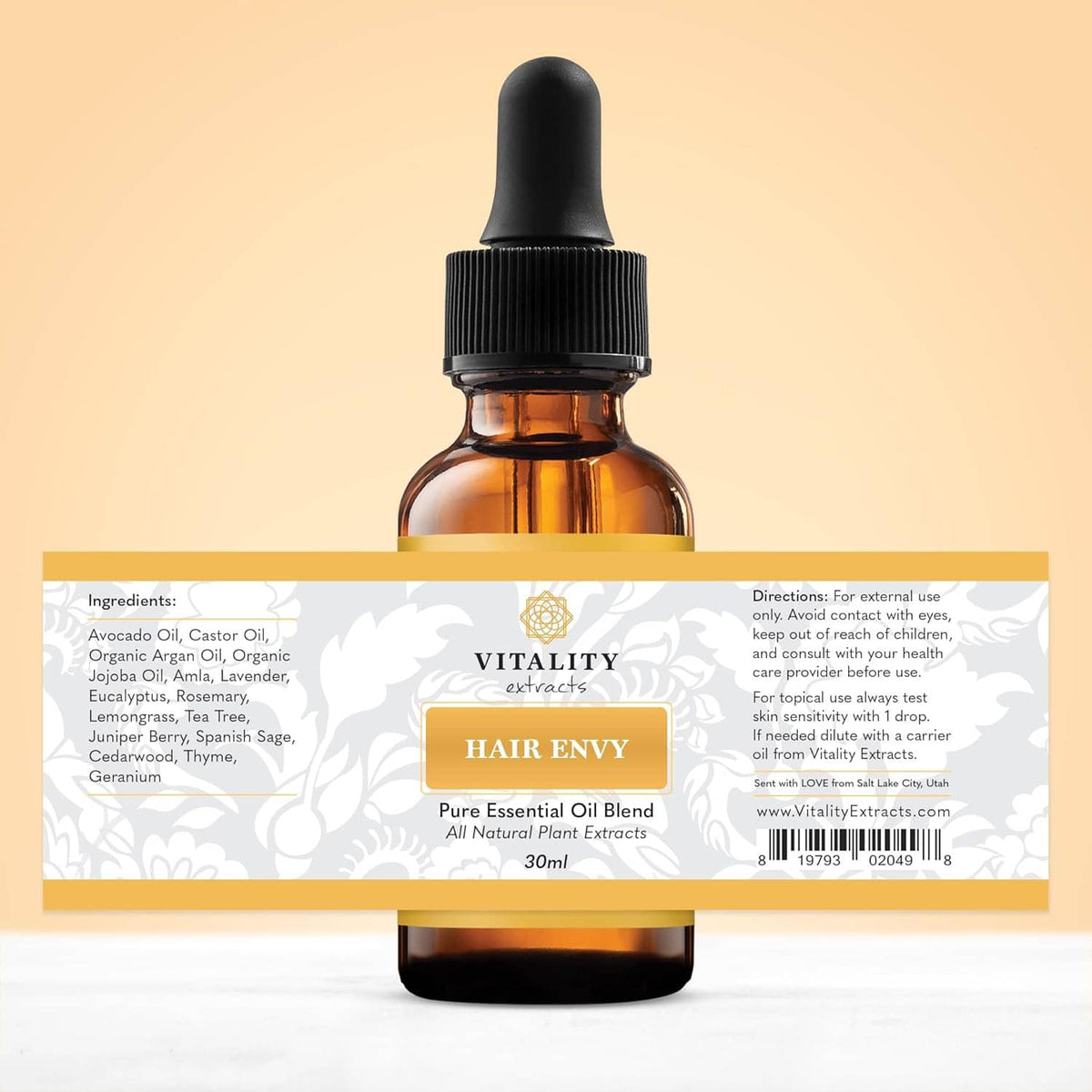Amber hair serum bottle with label and amber dropper, back-side ingredients panel