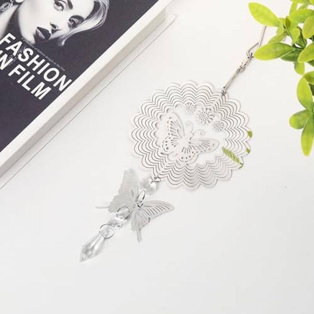 Silver butterfly wind spinner with scalloped sunburst disc and crystal drop charms.