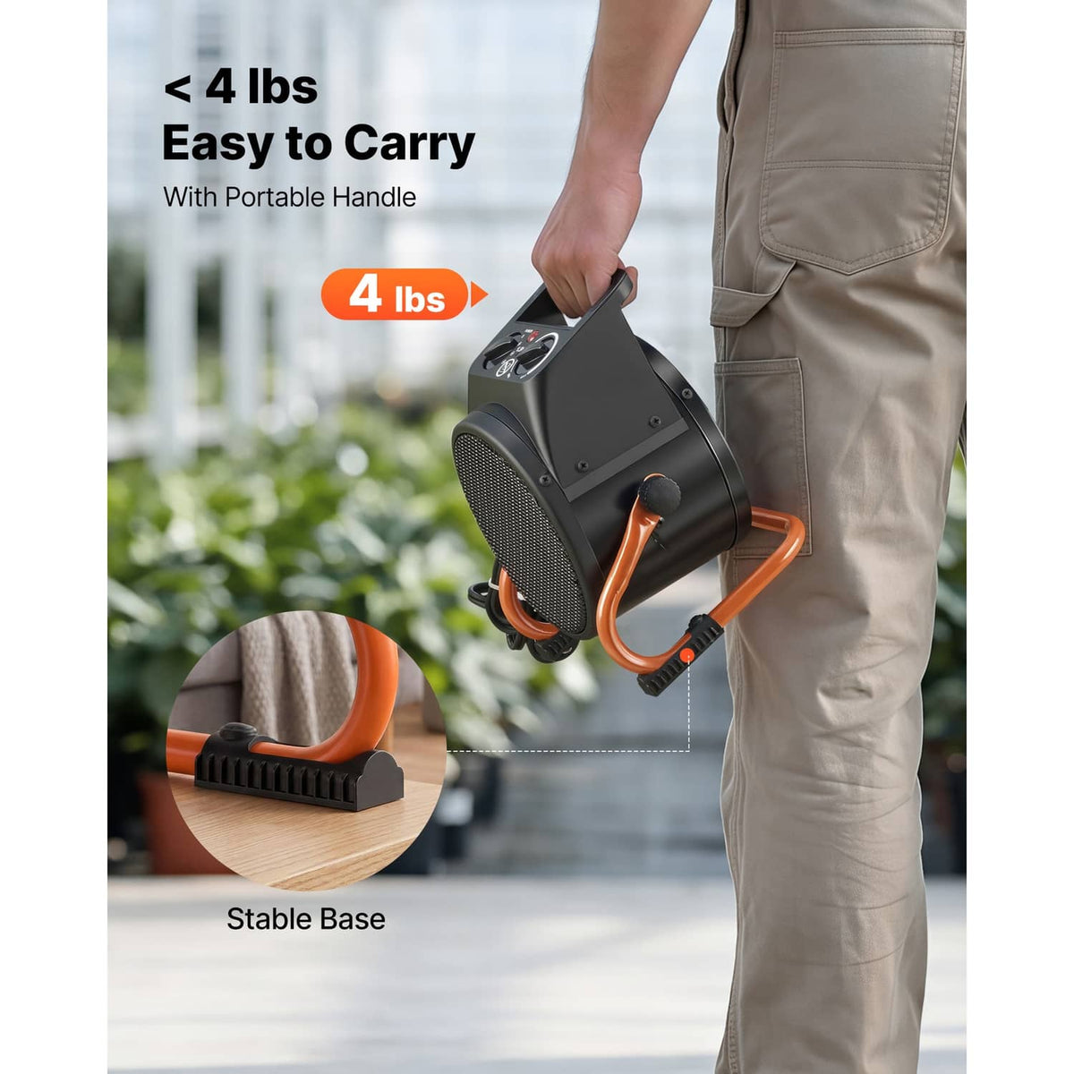 Electric greenhouse heater held by handle, showing front grill and orange base feet