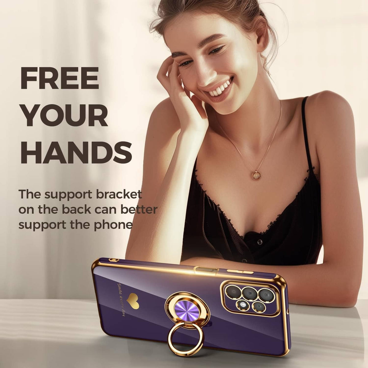 Purple phone case with gold ring holder, triple-camera cutout, and heart detail