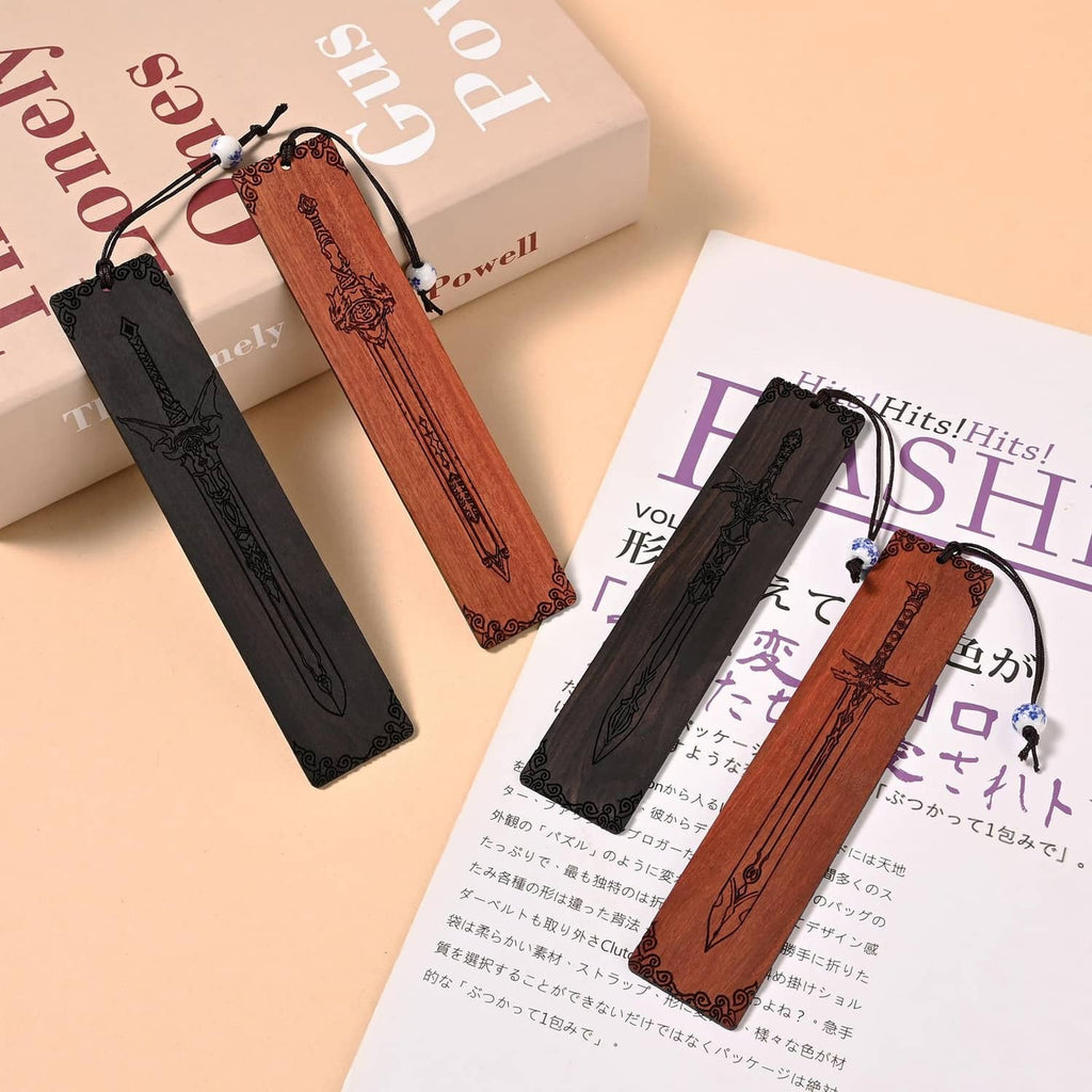 Four sword bookmarks tied with cords, black and brown on books and printed pages