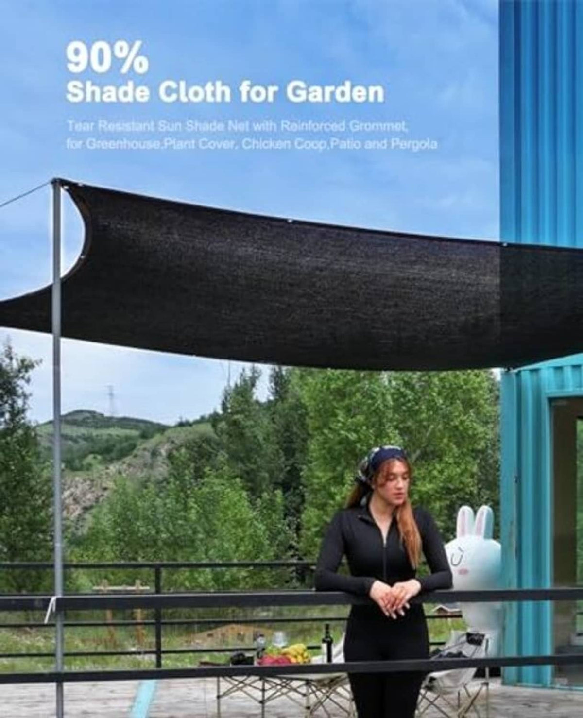 Black garden shade cloth stretched overhead, attached to poles for sun protection