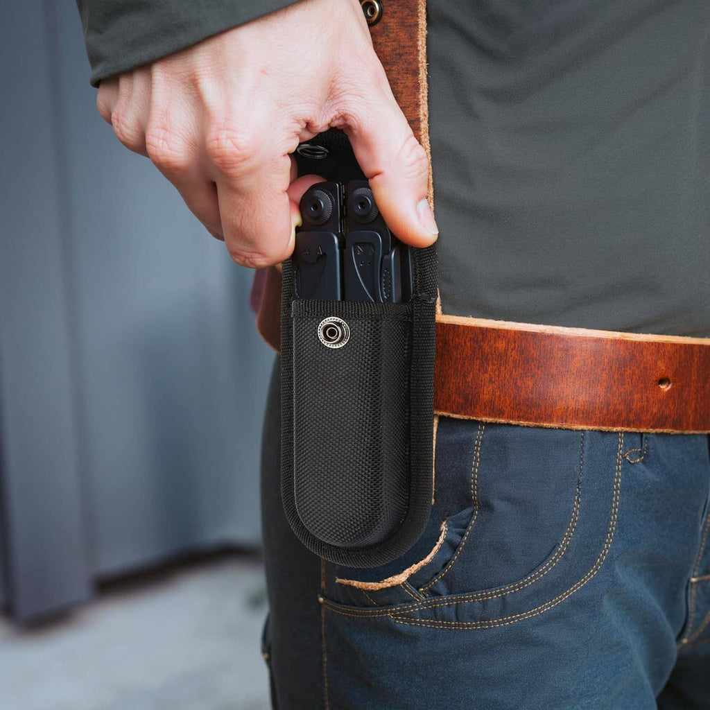 Black nylon knife sheath with snap closure attached to belt loop on pants.