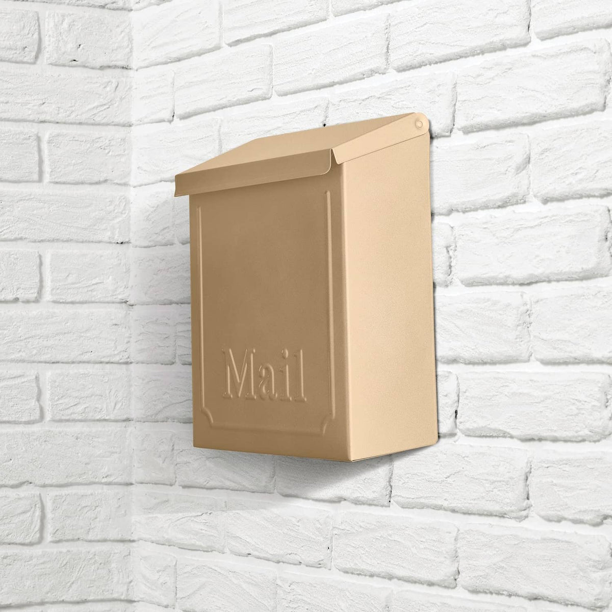 Metallic bronze mailbox with hinged lid on brick wall