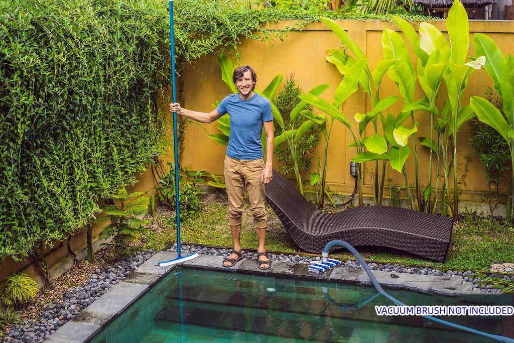 Blue telescopic pool pole extended into backyard pool for cleaning
