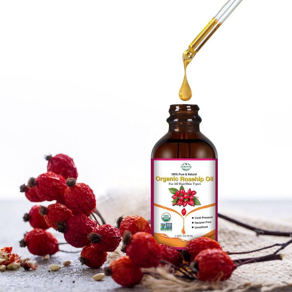 Rosehip seed oil bottle with dropper tip dripping golden oil and rosehips