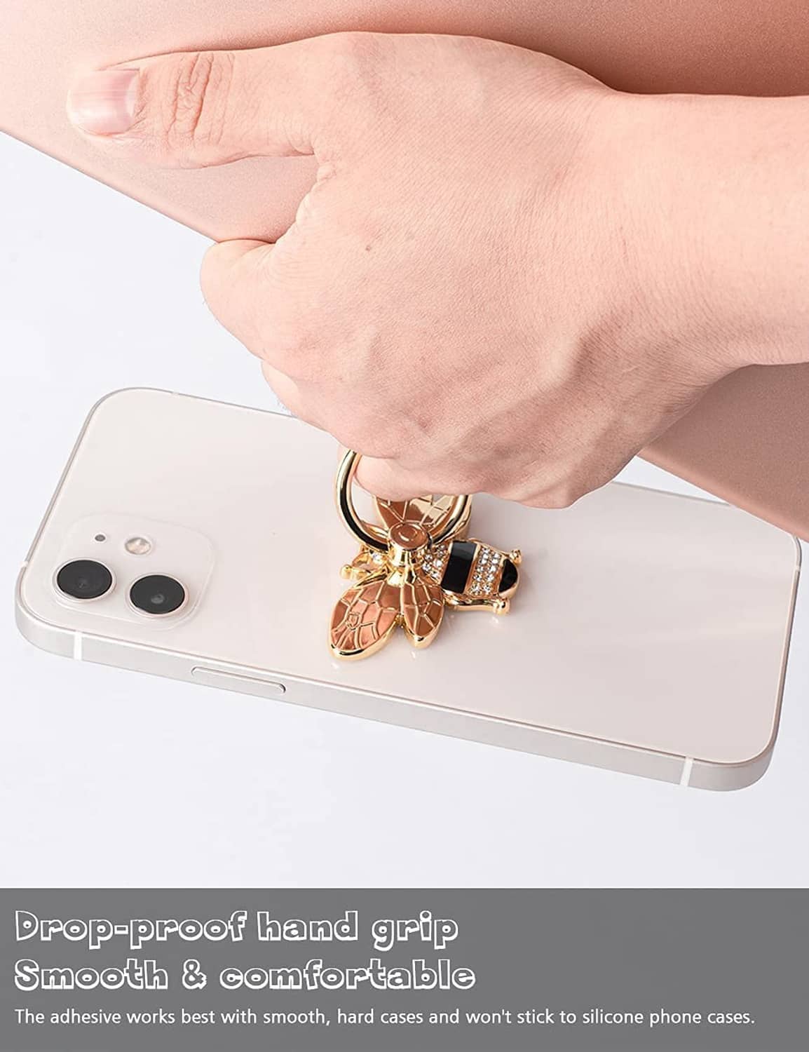 Gold bee phone ring holder kickstand on phone back, held by a hand