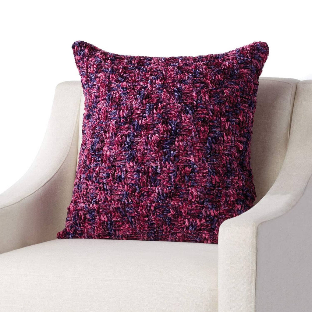 Maroon speckled knit pillow cover with a fuzzy, textured surface.