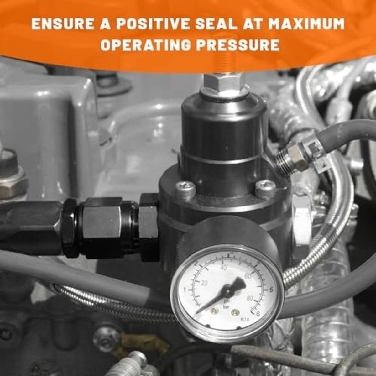Installed black flare reducer adapter with threaded ports and nearby pressure gauge.