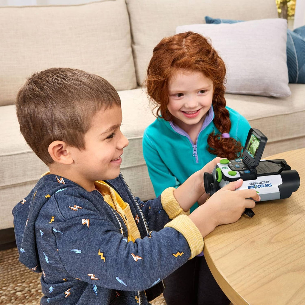 Two children holding LeapFrog-style binoculars, screen visible on device