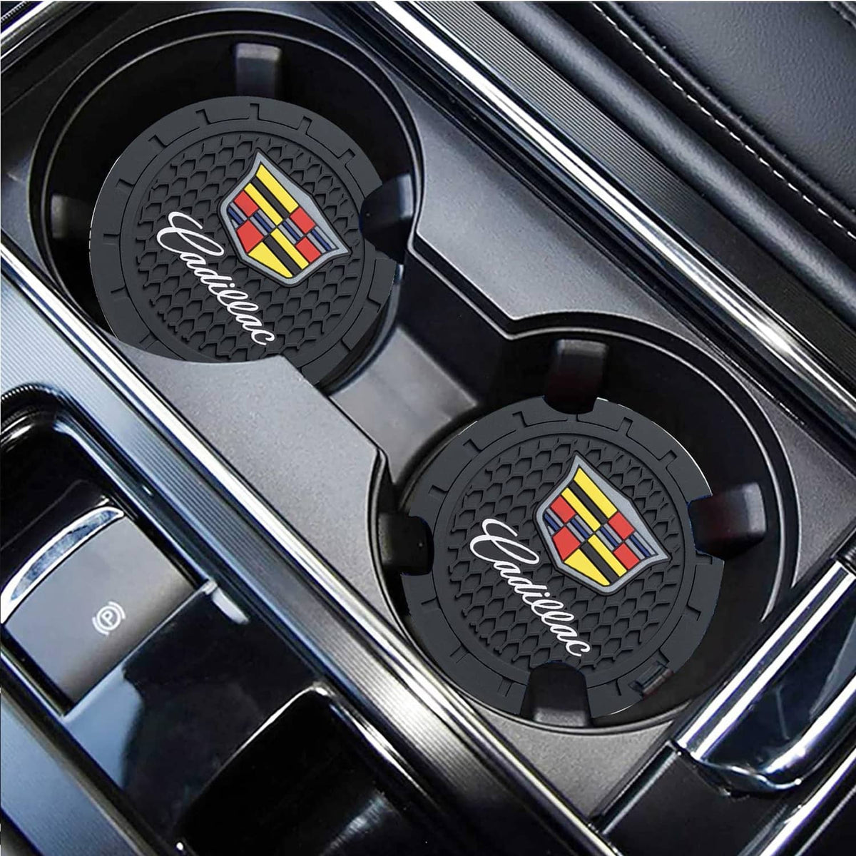 Black silicone cup holder coasters with Cadillac crest, angled view in console